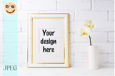 Gold decorated frame mockup with soft yellow orchid in vase
