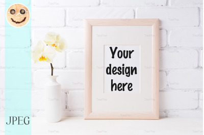 Wooden frame mockup with soft yellow orchid in vase