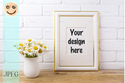 Gold decorated frame mockup with chamomile bouquet in rustic vase