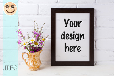 Black brown  frame mockup with chamomile and purple flowers in golden
