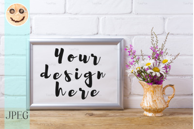 Silver landscape frame mockup with chamomile and purple flowers in gol