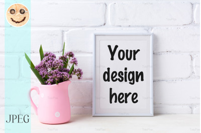 White frame mockup with purple flowers in pink rustic pitcher PSD Mockup Template