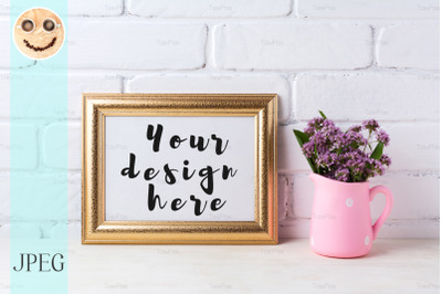 Golden  landscape frame mockup with purple flowers in pink rustic pitc