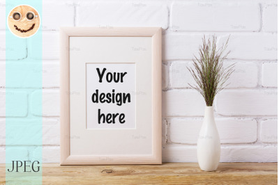 Wooden frame mockup with dark grass in elegant vase