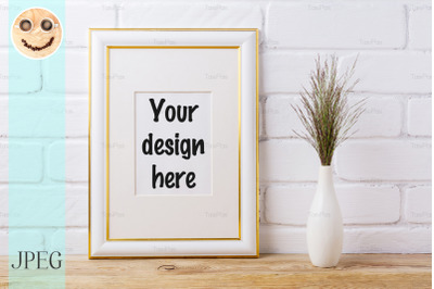 Gold decorated frame mockup with dark grass in elegant vase