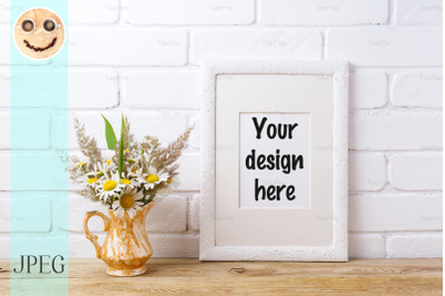 White frame mockup with chamomile and grass in golden vase