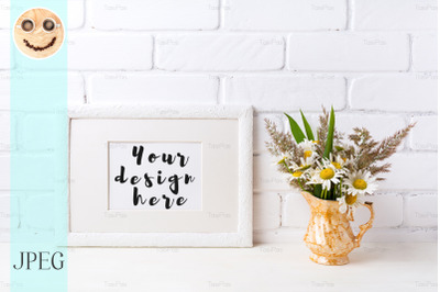 White landscape frame mockup with chamomile and grass in golden vase