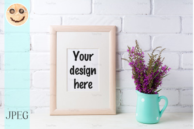 Wooden frame mockup with maroon purple flowers in mint pitcher