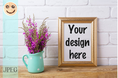 Golden  frame mockup with maroon purple flowers in mint pitcher