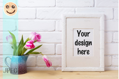 White frame mockup with pink tulip in blue pitcher