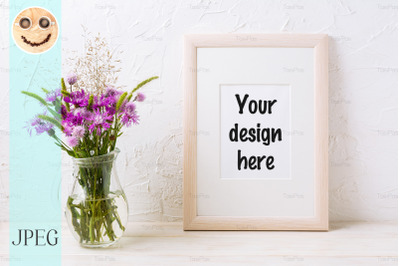 Wooden frame mockup with purple burdocks in jug