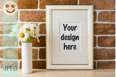 Gold decorated frame mockup with daisy bouquet exposed brick wall