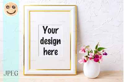 Gold decorated frame mockup with flower bouquet in flowerpot