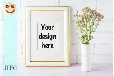 Gold decorated frame mockup with pink flowers in cylinder vase