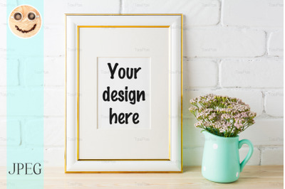 Gold decorated frame mockup with soft pink flowers and bricks