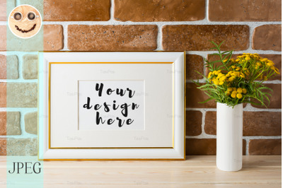 Gold decorated landscape frame mockup near exposed brick walls