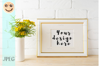 Gold decorated landscape frame mockup near painted brick walls