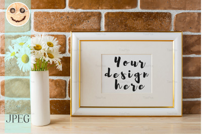 Gold decorated landscape frame mockup with daisy bouquet in vase