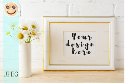 Gold decorated landscape frame mockup with daisy flower in vase