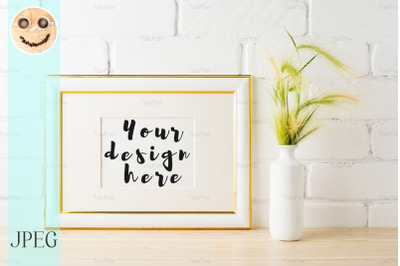 Gold decorated landscape frame mockup with green wild grass ears