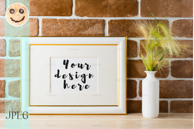 Gold decorated landscape frame mockup with ornamental grass in styled