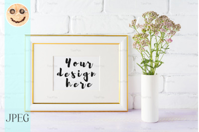 Gold decorated landscape frame mockup with wild creamy pink flowers