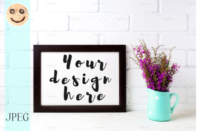 Wooden frame mockup with magenta flowers in mint pitcher