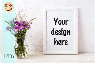 White frame mockup with burdock flowers in the jug