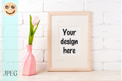 Wooden frame mockup with pink tulip in swirled vase