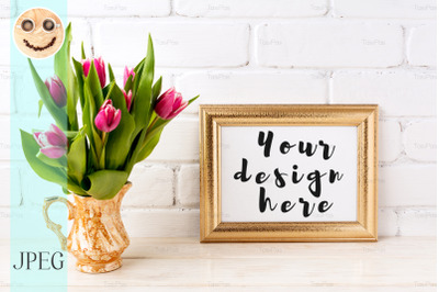 Golden  landscape frame mockup with pink tulips in jug