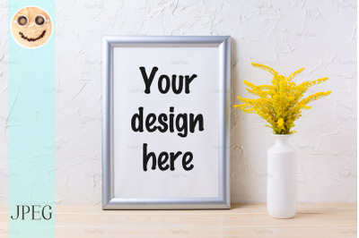 Silver frame mockup with ornamental yellow flowering grass in vase