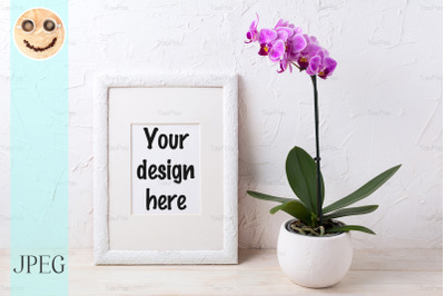 White frame mockup with purple orchid in flower pot