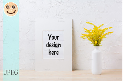 White mat frame mockup with ornamental yellow flowering grass in vase