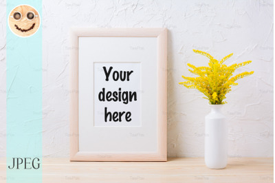 Wooden frame mockup with ornamental yellow flowering grass in vase
