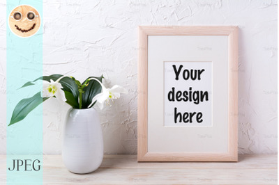 Wooden frame mockup with tender white lily in vase