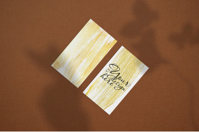 Business card Mock up. Natural overlay lighting shadows the leaves