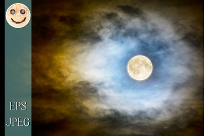 Full moon over dark cloudy sky