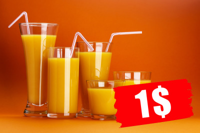 Glass of orange juice isolated on orange background with copy space
