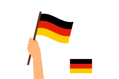 Human hand holding flag of Germany