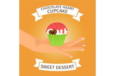 Hand holding cupcake with chocolate heart,