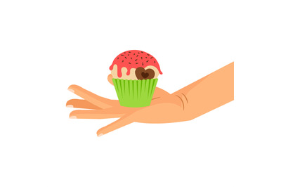 Hand holding cupcake with chocolate heart