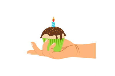 Hand holding cupcake with candle