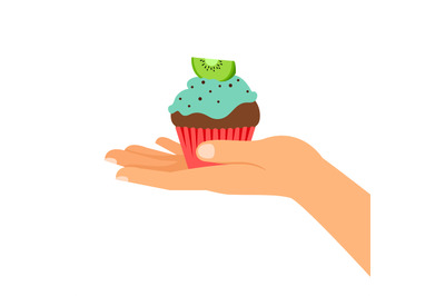 Hand holding cupcake with kiwi