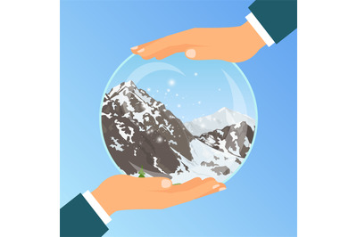 Hand holding glass bowl with mountains