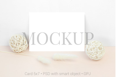 Mockup card with wooden balls and dry flowers