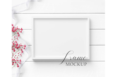 5x7 White Frame Mockup with white ribbon &amp; red flowers on white wood.
