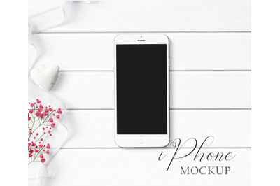 iPhone Mockup Styled with white ribbon and red flowers.