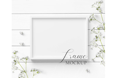 5x7 White Frame Mockup with white flowers on a white wood background.