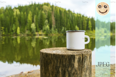 White campfire mug mockup with river bank view.