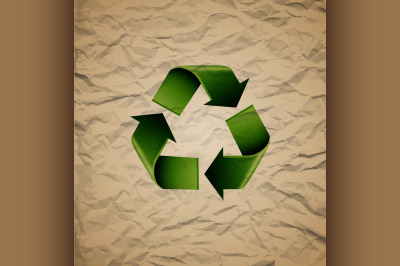 Green recycle symbol on crumpled cardboard